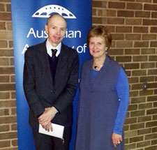 David Hush with woman beside a blue doorway with AAS logo